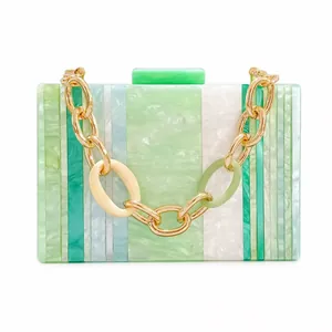 Detailed close-up of marble pattern acrylic clutch with chunky gold and resin chain