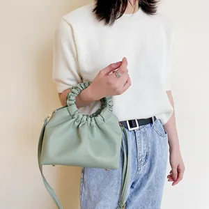Chic light green ruched cloud bag with round handle and shoulder strap for women