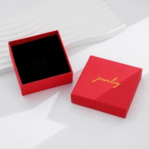 Macro detail of red jewelry gift box with gold logo and soft black velvet lining