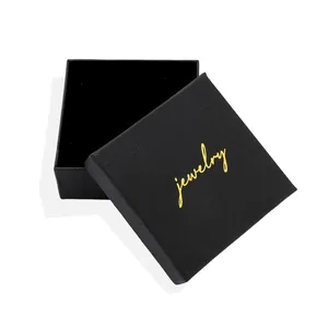 Textured black square jewelry gift box with gold jewelry logo and soft velvet interior