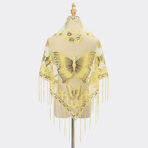 Detailed embroidery of butterflies and floral patterns on yellow lace triangle shawl with tassels