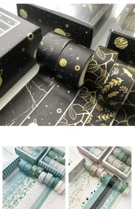 Detailed view of gold-foiled washi tape sets featuring celestial and marble patterns
