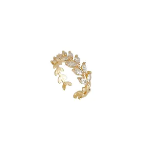 Elegant gold leaf open ring with marquise-cut zircon leaves on a minimalist white background