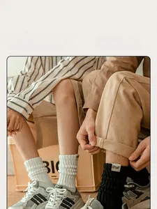 Detail of thick retro knit pile socks in white and black paired with sneakers