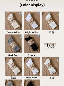 Detailed color display of ribbed crew socks in white, black and grey with towel bottom