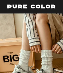 Close-up of white cotton knitted crew socks with vertical ribbed texture on a model