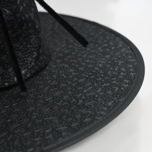 Close-up of black wizard hat with textured fabric and 3D droplet effect details