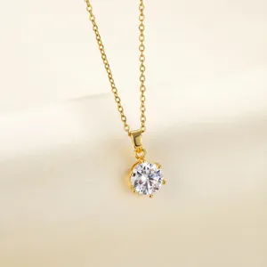 Close-up of 18K gold plated necklace featuring a classic six-prong zircon pendant detail