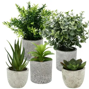 Set of four artificial green plants in minimalist concrete-textured pots for home decor