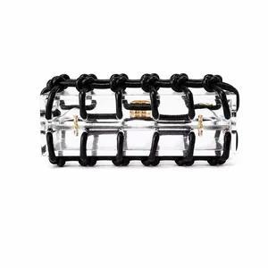 Close-up of clear acrylic box clutch with black braided rope cage and gold metal clasp