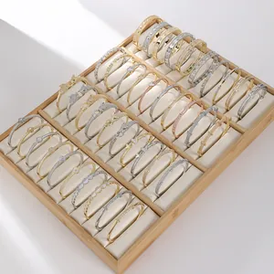 Collection of gold and silver plated bracelets with diverse trendy designs on a display tray