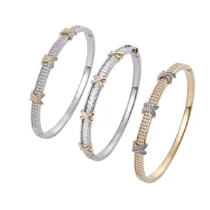 Two-tone crisscross bangle set with sparkling crystals and a secure metal clasp