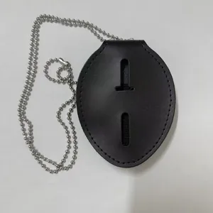 Detail of black leather badge holder with oval cutout and silver ball chain necklace