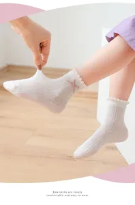 Close-up of girls mesh socks featuring pink bows and breathable knit texture