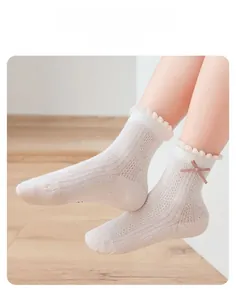 Close-up of girl's breathable mesh socks with pink ribbon bow and wavy cuffs