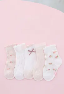 Detail of 5 pairs of pink floral girls' mesh socks with bows and ruffled edges