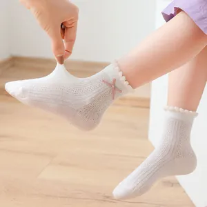 Girls mesh knee high socks with pink lace trim and bow detail for summer
