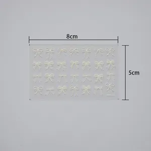Detail view of 5D embossed white bow nail stickers with 3D texture and 8cm x 5cm size