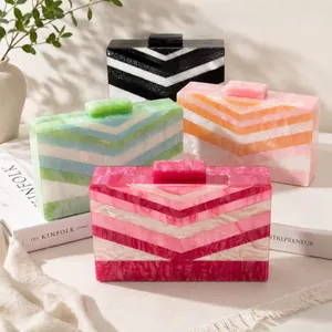 Four colorful acrylic clutch bags with geometric V-shaped patterns and marble textures