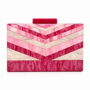 Detail view of pink and ivory chevron pattern on acrylic clutch bag with clasp