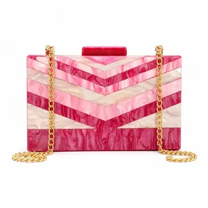 Macro view of the pink and beige chevron marble pattern on the acrylic evening bag