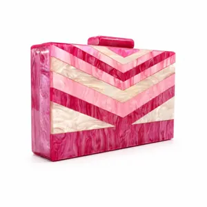 Macro shot of luxury pink marble acrylic clutch bag showing detailed V-shaped patterns