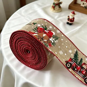 Detail of 6cm burlap Christmas ribbon with red truck and bell patterns for gift wrapping