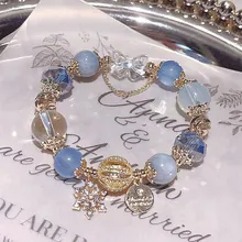 Detailed macro view of beaded bracelet with snowflake charms and butterfly accents