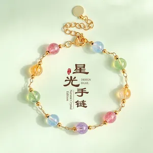 Macro view of natural multicolor crystal beads and gold metal spacers on this bracelet