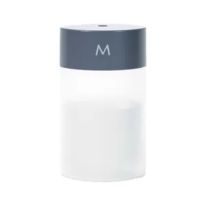 Portable USB humidifier with sleek cylindrical design and mist output for home office use