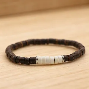 Multilayer coconut shell and wooden beaded bracelet set with white accents on wood table