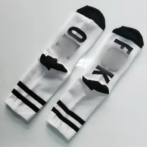 Detail of white cotton crew socks with 3D wing heel patches and bold letter design