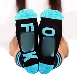 Detailed view of mid-calf cotton socks featuring Fuck Off printed text on the soles