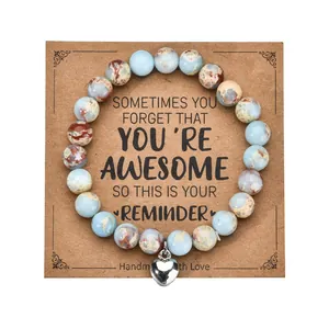 Detail of 8mm zebra stone heart bracelet on a vintage style kraft paper gift card display