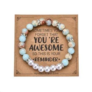 Beaded bracelet with blue marble stones and pearls displayed on a kraft quote card