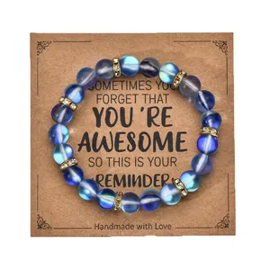 Close-up of blue frosted beaded bracelet with gold rhinestone spacers on gift card