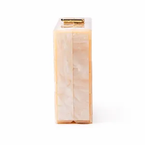 Detailed side view of beige marble acrylic clutch with elegant golden metal clasp