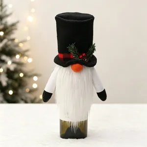 Detail of Christmas gnome wine bottle cover with felt top hat and plush beard on table