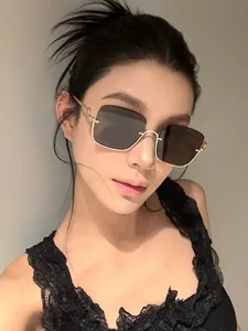 Fashionable half-frame sunglasses with gold metal frame worn by a model for face-shaping