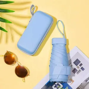 Mini light blue 5-fold sun umbrella with matching hard shell case and palm leaf shadow