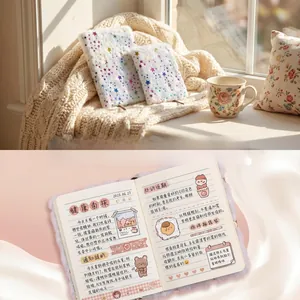 Close-up of plush white notebook cover with rainbow stars and lined interior pages