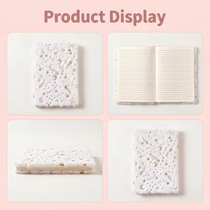 White plush notebook with gold foil star and moon pattern, featuring soft faux fur cover