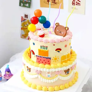 Detailed view of cartoon bear cake topper set with balloons and colorful spiral candles