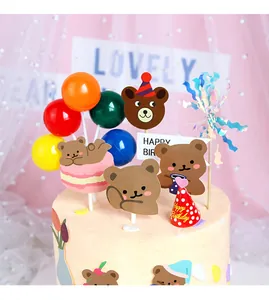 Detail of cute bear cake toppers with colorful balloons and Happy Birthday sign