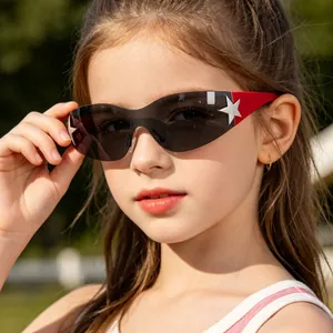 Kids sports sunglasses with red oversized frame and silver star detail in outdoor setting