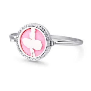 Close-up of silver diffuser bracelet with rhinestone bezel and pink aroma pad
