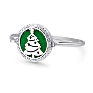 Detailed macro view of silver aromatherapy diffuser bracelet with Christmas tree locket