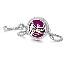 Detail of silver aromatherapy bracelet with musical note locket and purple felt pad