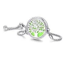 Close-up of tree of life locket bracelet with green felt pad and box chain