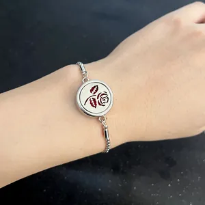 Detail of silver stainless steel diffuser bracelet with a hollow rose locket on wrist